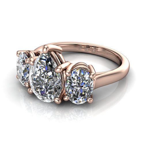 Imogen pear three stone engagement ring in 18K Rose Gold, three-quarter perspective showing the center diamond between two round side stones on a slim polished band