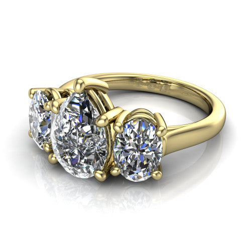 Imogen pear three stone engagement ring in 18K Yellow Gold, three-quarter perspective showing the center diamond between two round side stones on a slim polished band