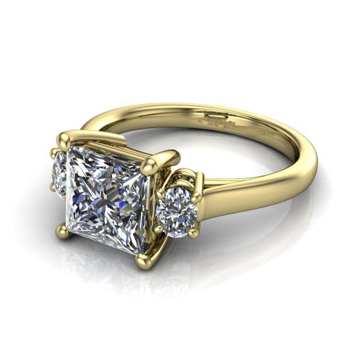 Imogen princess three stone engagement ring in 14K Yellow Gold, three-quarter perspective showing the center diamond between two round side stones on a slim polished band