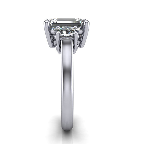 Imogen emerald three stone engagement ring in Platinum, side profile showing the round side stone and the smooth tapered polished band