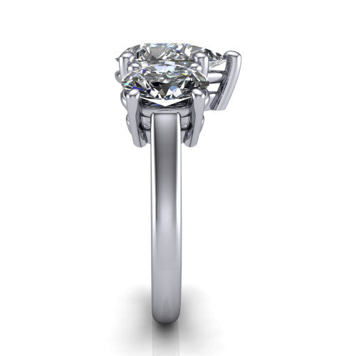 Imogen pear three stone engagement ring in 14K White Gold, side profile showing the round side stone and the smooth tapered polished band