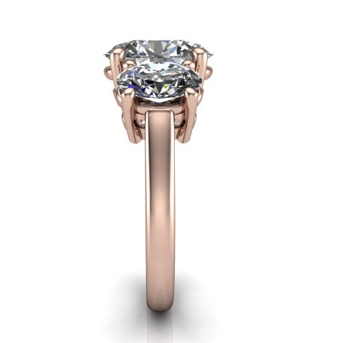 Imogen oval three stone engagement ring in 14K Rose Gold, side profile showing the round side stone and the smooth tapered polished band