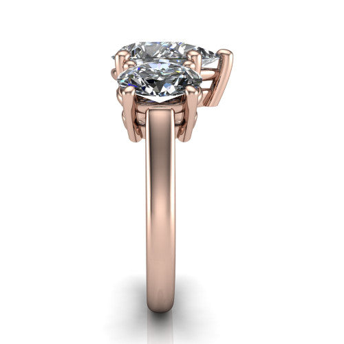 Imogen pear three stone engagement ring in 14K Rose Gold, side profile showing the round side stone and the smooth tapered polished band