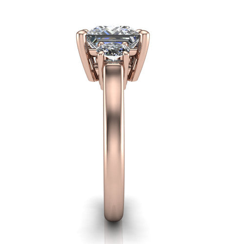 Imogen princess three stone engagement ring in 14K Rose Gold, side profile showing the round side stone and the smooth tapered polished band