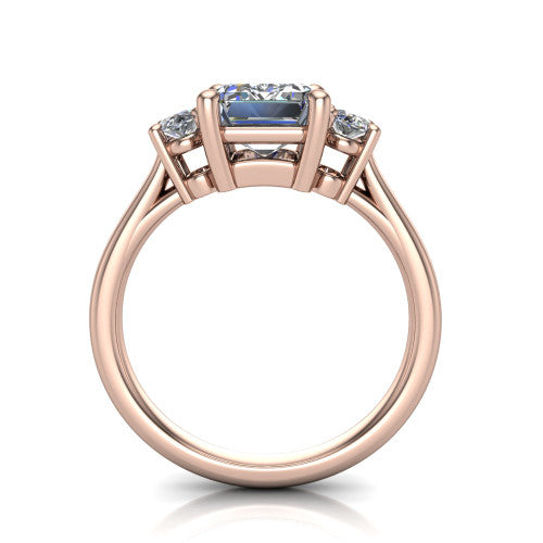 Imogen emerald three stone engagement ring in 14K Rose Gold, through-finger front profile showing the three-stone head raised above the slim polished shank and trellis gallery