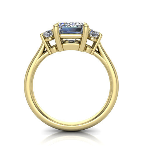 Imogen emerald three stone engagement ring in 18K Yellow Gold, through-finger front profile showing the three-stone head raised above the slim polished shank and trellis gallery