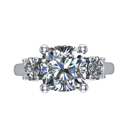 Imogen cushion three stone engagement ring in Platinum, top-down view showing the center diamond flanked by two round side stones in a classic three stone setting