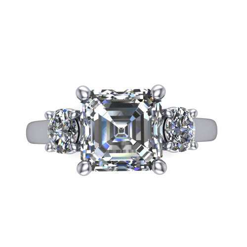 Imogen asscher three stone engagement ring in 18K White Gold, top-down view showing the center diamond flanked by two round side stones in a classic three stone setting