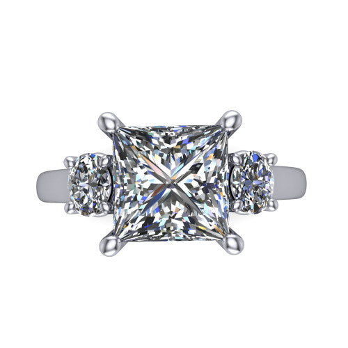 Imogen princess three stone engagement ring in 18K White Gold, top-down view showing the center diamond flanked by two round side stones in a classic three stone setting