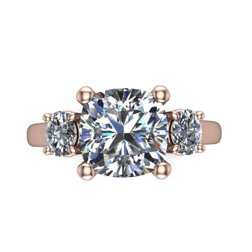 Imogen cushion three stone engagement ring in 14K Rose Gold, top-down view showing the center diamond flanked by two round side stones in a classic three stone setting