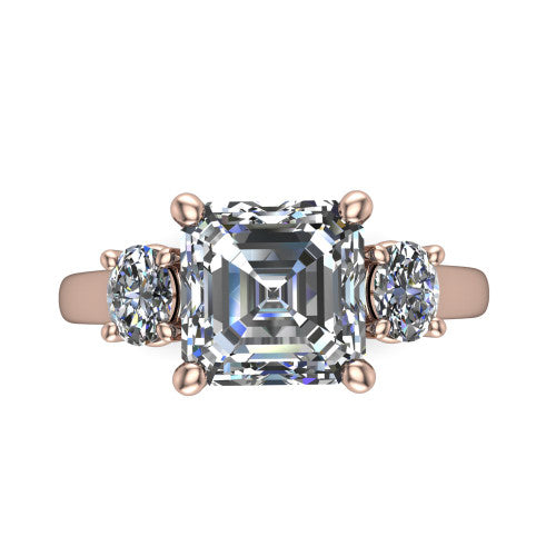 Imogen asscher three stone engagement ring in 14K Rose Gold, top-down view showing the center diamond flanked by two round side stones in a classic three stone setting
