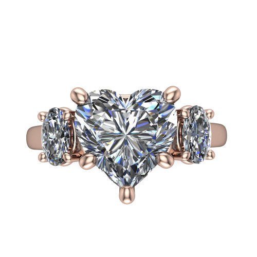 Imogen heart three stone engagement ring in 14K Rose Gold, top-down view showing the center diamond flanked by two round side stones in a classic three stone setting