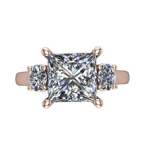 Imogen princess three stone engagement ring in 18K Rose Gold, top-down view showing the center diamond flanked by two round side stones in a classic three stone setting