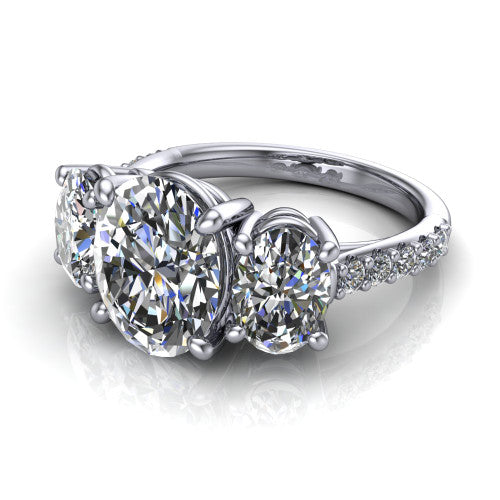 Poppy oval three stone engagement ring in Platinum, three-quarter perspective showing the center diamond between two round side stones above a pav&eacute; shank