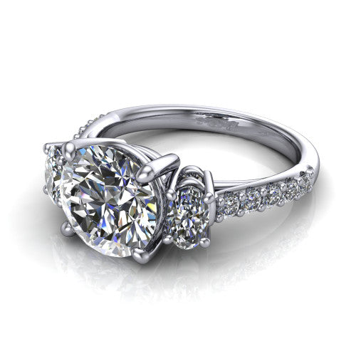 Poppy round three stone engagement ring in Platinum, three-quarter perspective showing the center diamond between two round side stones above a pav&eacute; shank