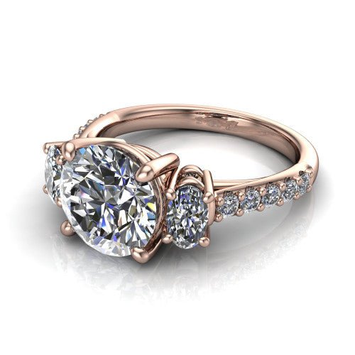 Poppy round three stone engagement ring in 18K Rose Gold, three-quarter perspective showing the center diamond between two round side stones above a pav&eacute; shank