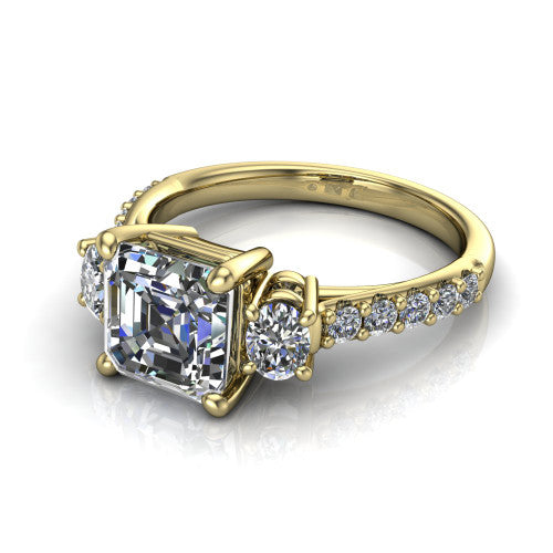 Poppy asscher three stone engagement ring in 18K Yellow Gold, three-quarter perspective showing the center diamond between two round side stones above a pav&eacute; shank