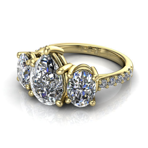 Poppy pear three stone engagement ring in 18K Yellow Gold, three-quarter perspective showing the center diamond between two round side stones above a pav&eacute; shank