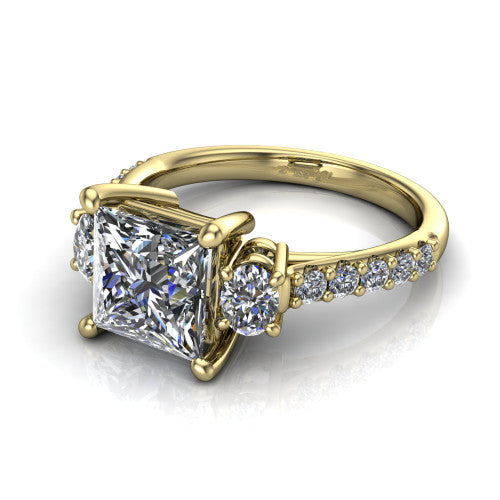 Poppy princess three stone engagement ring in 18K Yellow Gold, three-quarter perspective showing the center diamond between two round side stones above a pav&eacute; shank