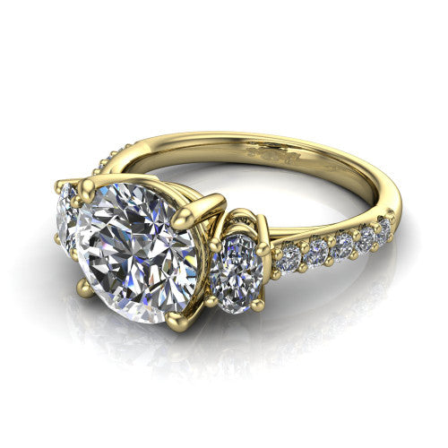 Poppy round three stone engagement ring in 14K Yellow Gold, three-quarter perspective showing the center diamond between two round side stones above a pav&eacute; shank