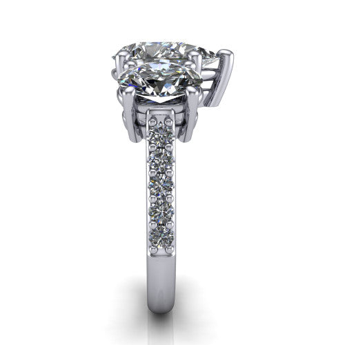 Poppy pear three stone engagement ring in 14K White Gold, side profile showing the round side stone and the pav&eacute; diamonds running down the shank