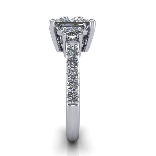 Poppy princess three stone engagement ring in Platinum, side profile showing the round side stone and the pav&eacute; diamonds running down the shank