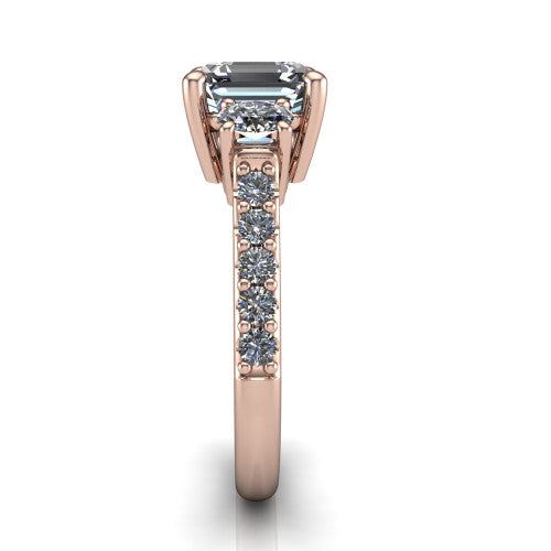Poppy asscher three stone engagement ring in 14K Rose Gold, side profile showing the round side stone and the pav&eacute; diamonds running down the shank