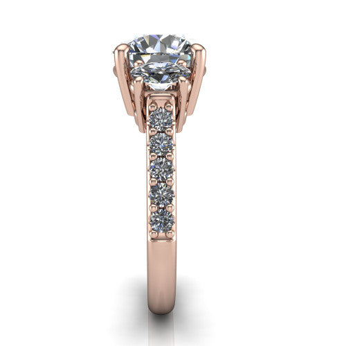 Poppy round three stone engagement ring in 14K Rose Gold, side profile showing the round side stone and the pav&eacute; diamonds running down the shank