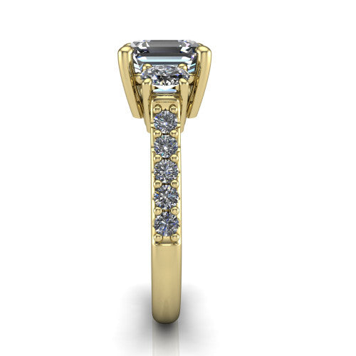 Poppy asscher three stone engagement ring in 18K Yellow Gold, side profile showing the round side stone and the pav&eacute; diamonds running down the shank