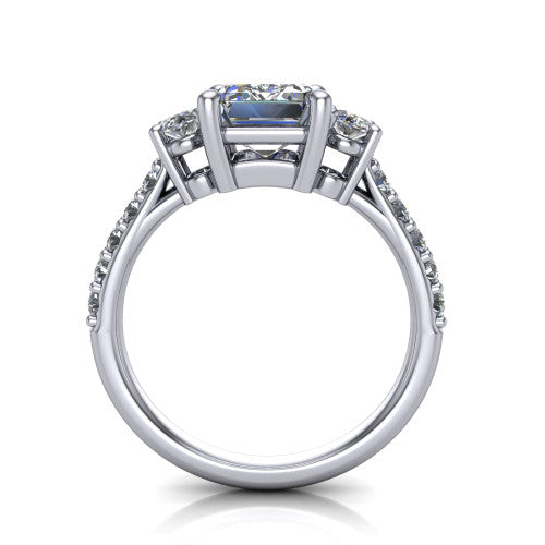 Poppy emerald three stone engagement ring in Platinum, through-finger front profile showing the three-stone head raised above the pav&eacute; band