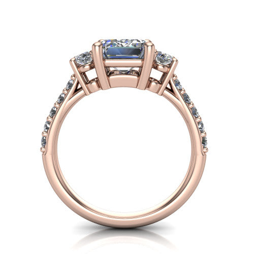 Poppy emerald three stone engagement ring in 18K Rose Gold, through-finger front profile showing the three-stone head raised above the pav&eacute; band