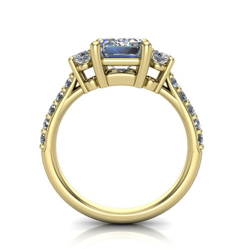 Poppy emerald three stone engagement ring in 18K Yellow Gold, through-finger front profile showing the three-stone head raised above the pav&eacute; band