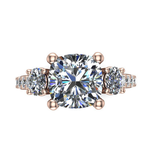 Poppy cushion three stone engagement ring in 18K Rose Gold, top-down view showing the center diamond flanked by two round side stones in a classic three stone setting