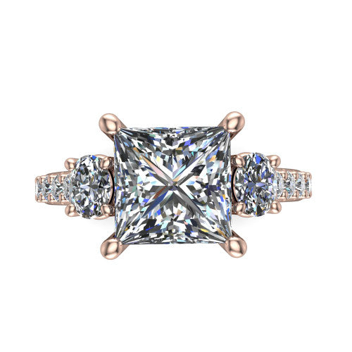 Poppy princess three stone engagement ring in 14K Rose Gold, side profile showing the round side stone and the pav&eacute; diamonds running down the shank