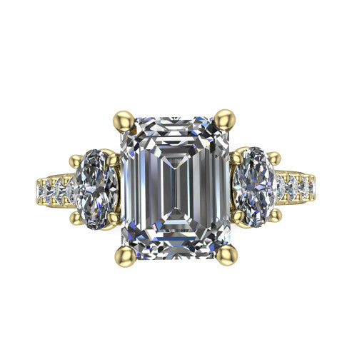 Poppy emerald three stone engagement ring in 18K Yellow Gold, top-down view showing the center diamond flanked by two round side stones in a classic three stone setting