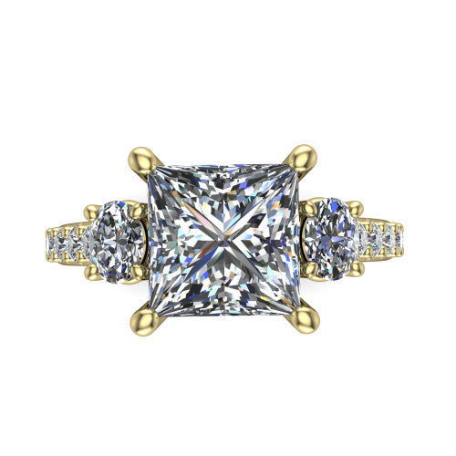 Poppy princess three stone engagement ring in 18K Yellow Gold, top-down view showing the center diamond flanked by two round side stones in a classic three stone setting