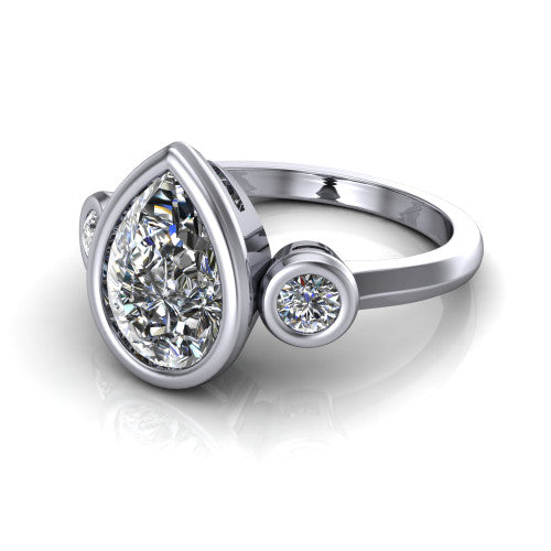 Daisy pear three stone engagement ring in 14K White Gold, three-quarter perspective showing the bezel-set center between two bezel-set round side stones on a slim polished band