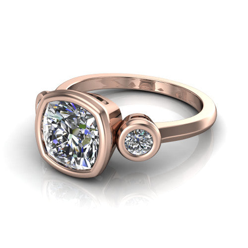 Daisy cushion three stone engagement ring in 14K Rose Gold, three-quarter perspective showing the bezel-set center between two bezel-set round side stones on a slim polished band
