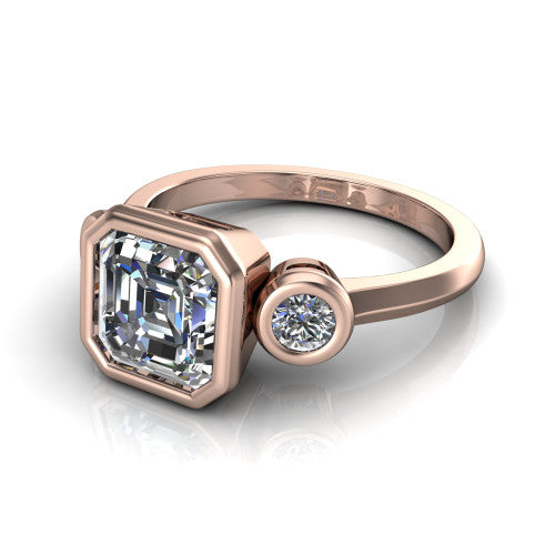 Daisy asscher three stone engagement ring in 18K Rose Gold, three-quarter perspective showing the bezel-set center between two bezel-set round side stones on a slim polished band