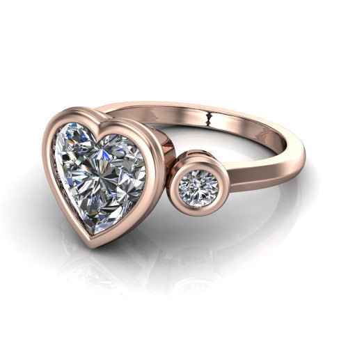 Daisy heart three stone engagement ring in 18K Rose Gold, three-quarter perspective showing the bezel-set center between two bezel-set round side stones on a slim polished band