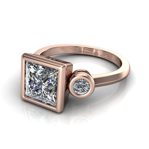 Daisy princess three stone engagement ring in 14K Rose Gold, three-quarter perspective showing the bezel-set center between two bezel-set round side stones on a slim polished band