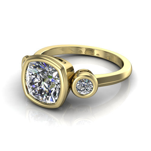 Daisy cushion three stone engagement ring in 18K Yellow Gold, three-quarter perspective showing the bezel-set center between two bezel-set round side stones on a slim polished band