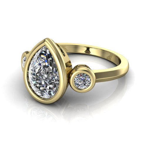 Daisy pear three stone engagement ring in 18K Yellow Gold, three-quarter perspective showing the bezel-set center between two bezel-set round side stones on a slim polished band