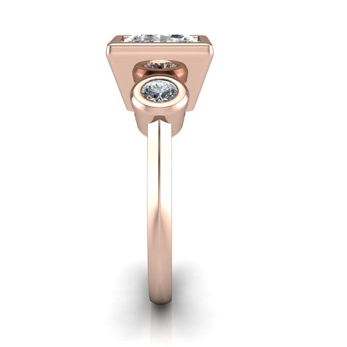Daisy princess three stone engagement ring in 14K Rose Gold, side profile showing the bezel-set round side stone and the smooth polished band