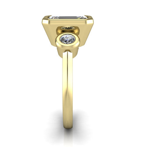 Daisy emerald three stone engagement ring in 18K Yellow Gold, side profile showing the bezel-set round side stone and the smooth polished band