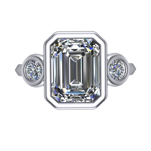 Daisy emerald three stone engagement ring in 14K White Gold, top-down view showing the bezel-set center diamond flanked by two round bezel-set side stones