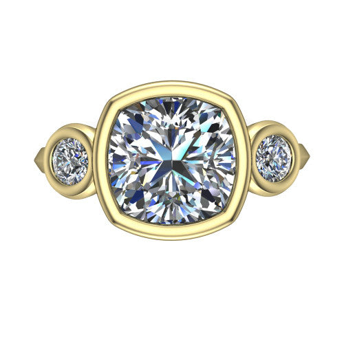 Daisy cushion three stone engagement ring in 18K Yellow Gold, top-down view showing the bezel-set center diamond flanked by two round bezel-set side stones