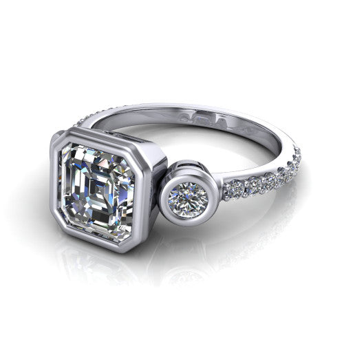 Chloe asscher three stone engagement ring in 14K White Gold, three-quarter perspective showing the bezel-set center between two bezel-set round side stones above a pav&eacute; shank
