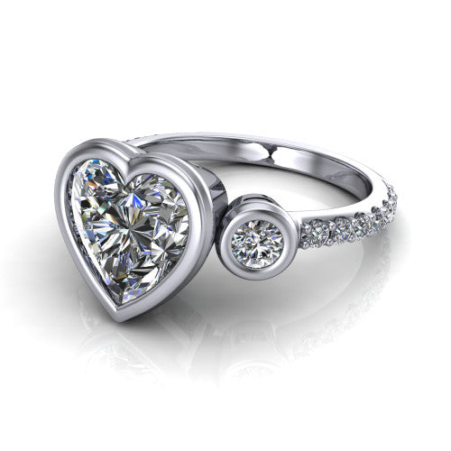 Chloe heart three stone engagement ring in 18K White Gold, three-quarter perspective showing the bezel-set center between two bezel-set round side stones above a pav&eacute; shank