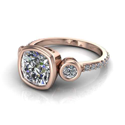 Chloe cushion three stone engagement ring in 18K Rose Gold, three-quarter perspective showing the bezel-set center between two bezel-set round side stones above a pav&eacute; shank